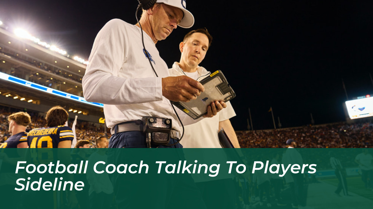 Football Coach Talking To Players Sideline
