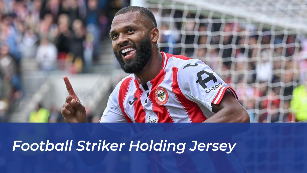 Football striker holding jersey